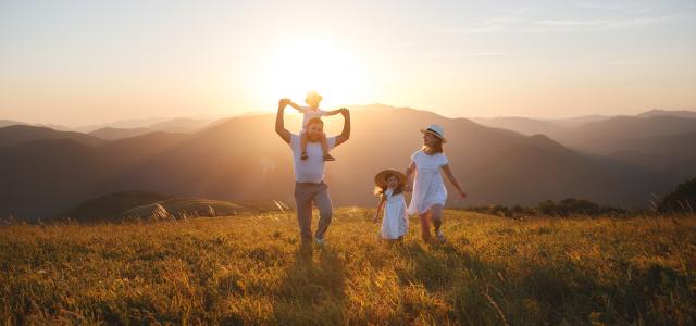 Happy family: mother, father, children son and daughter on sunset